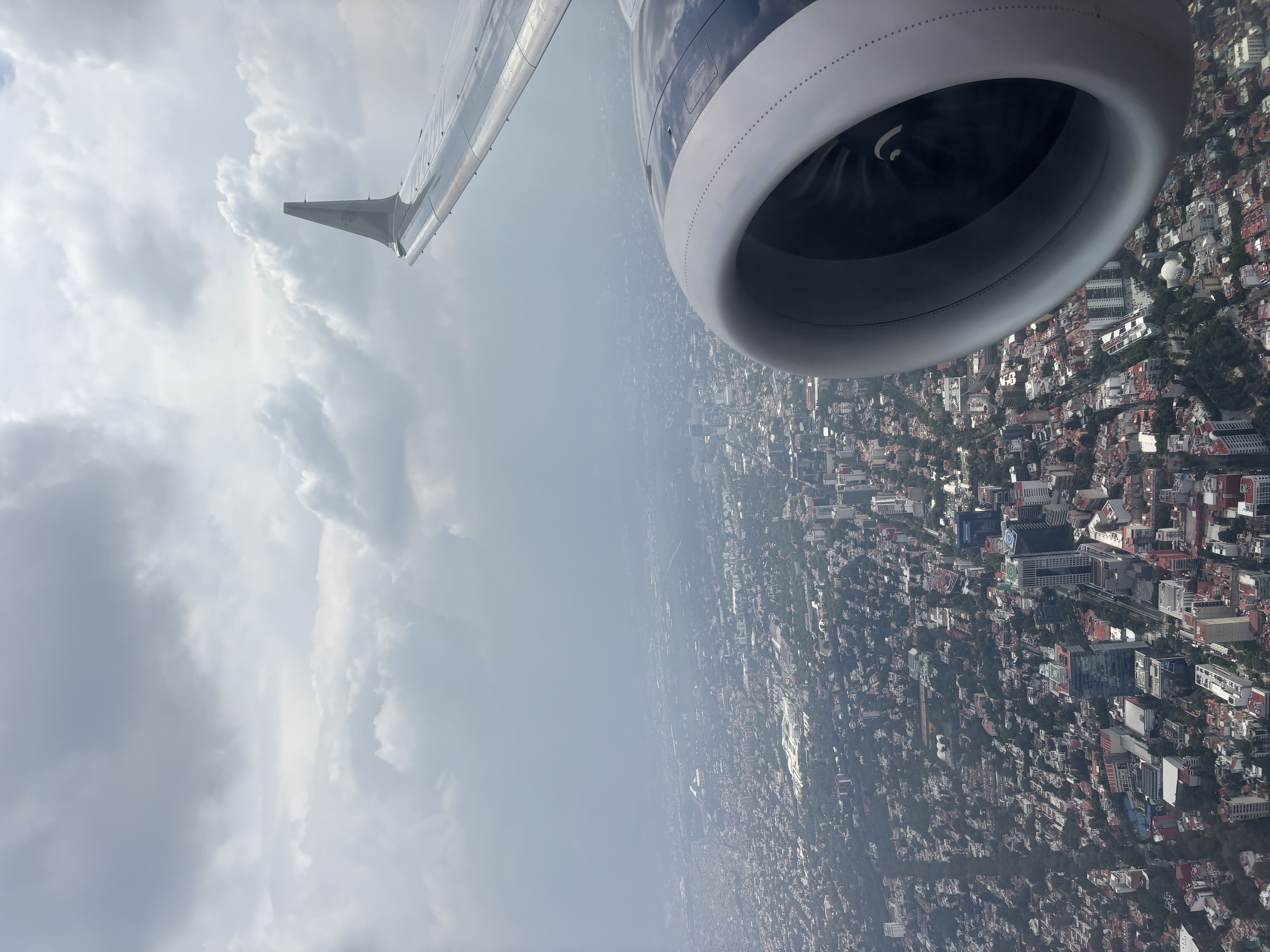 View out an airplane window showing approach over Mexico City.