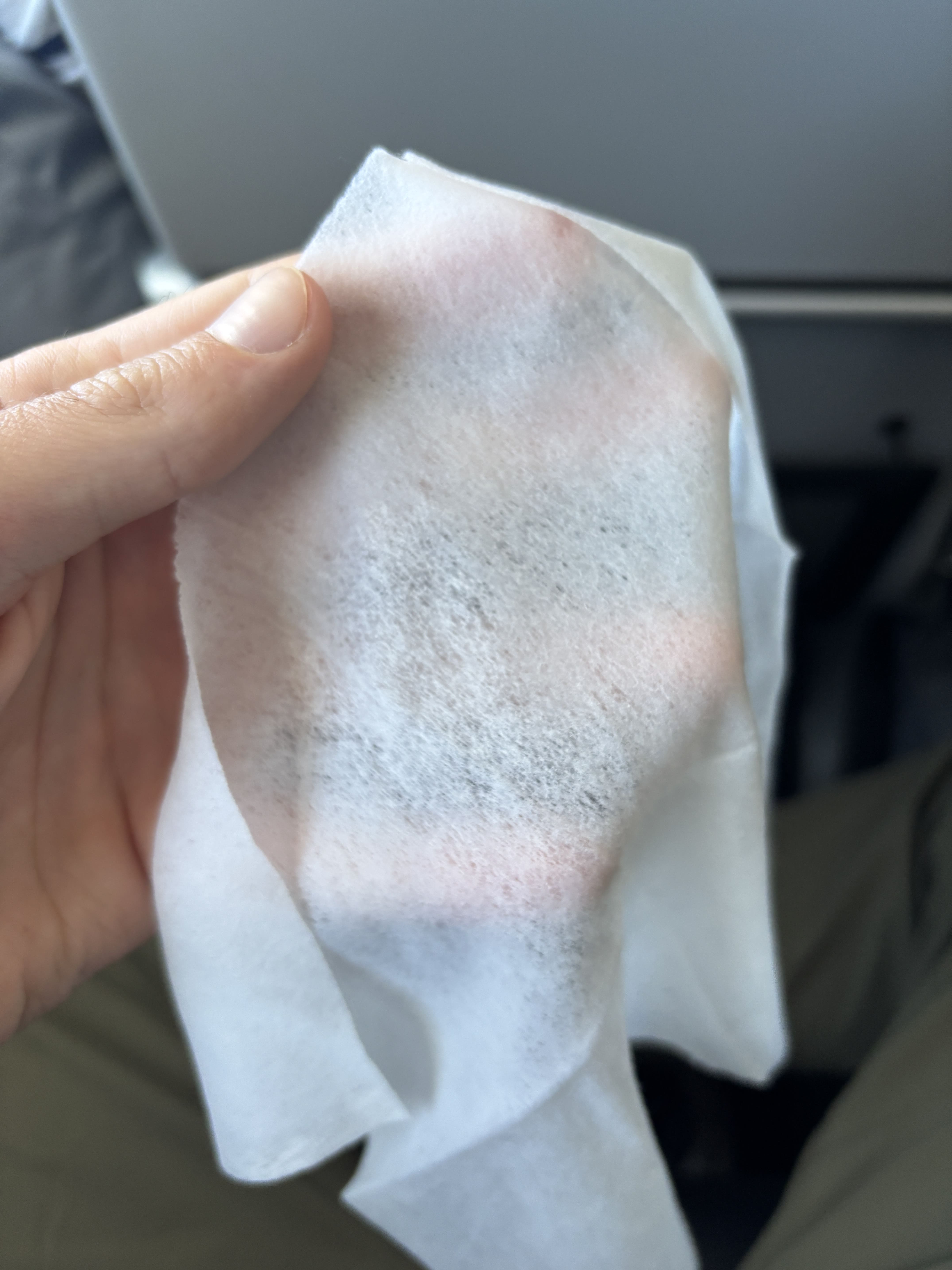 Thin, largely translucent hot towel distributed on Avianca regional business class.