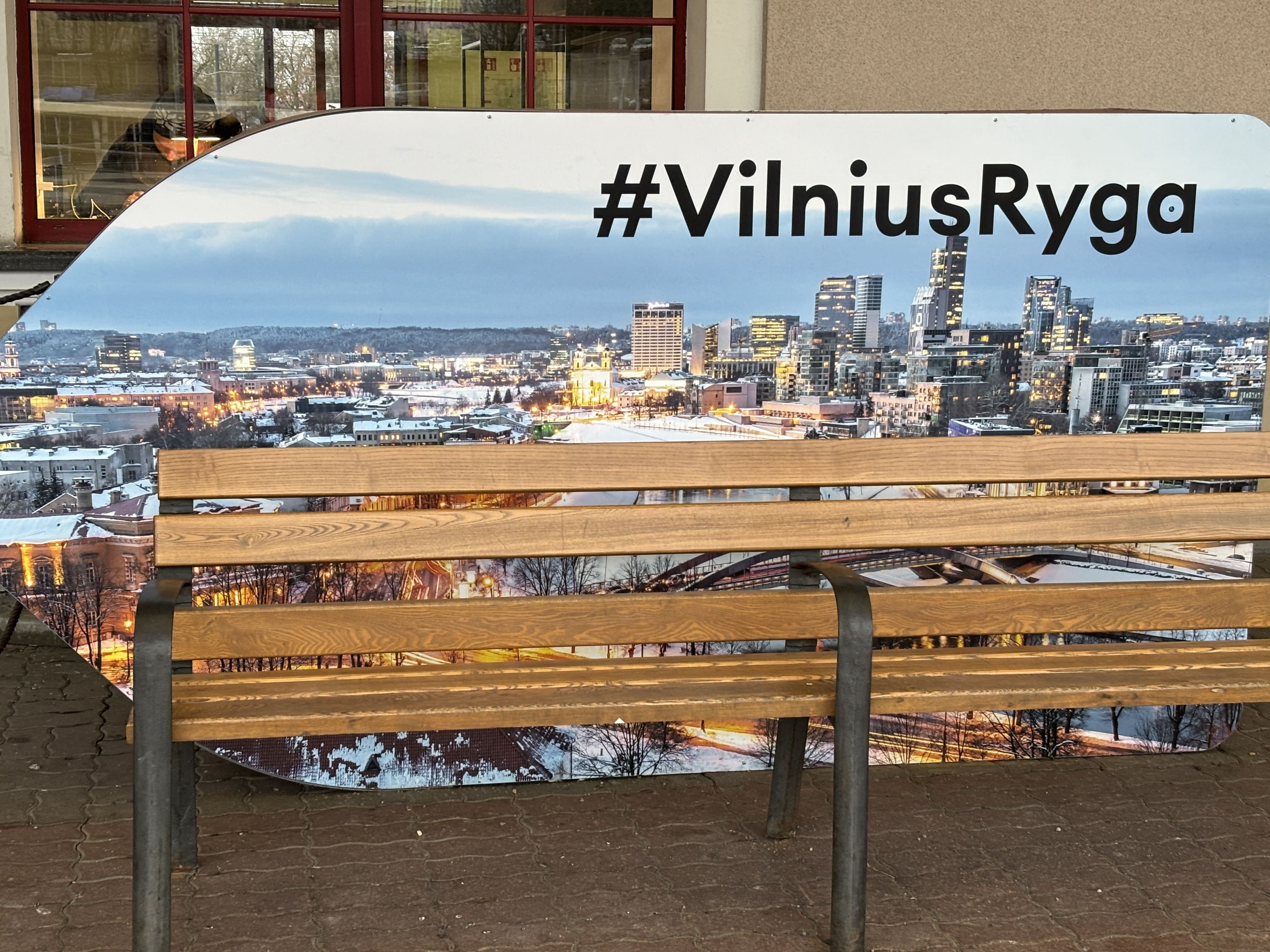 Sign advertising the Vilnius to Riga train connection.