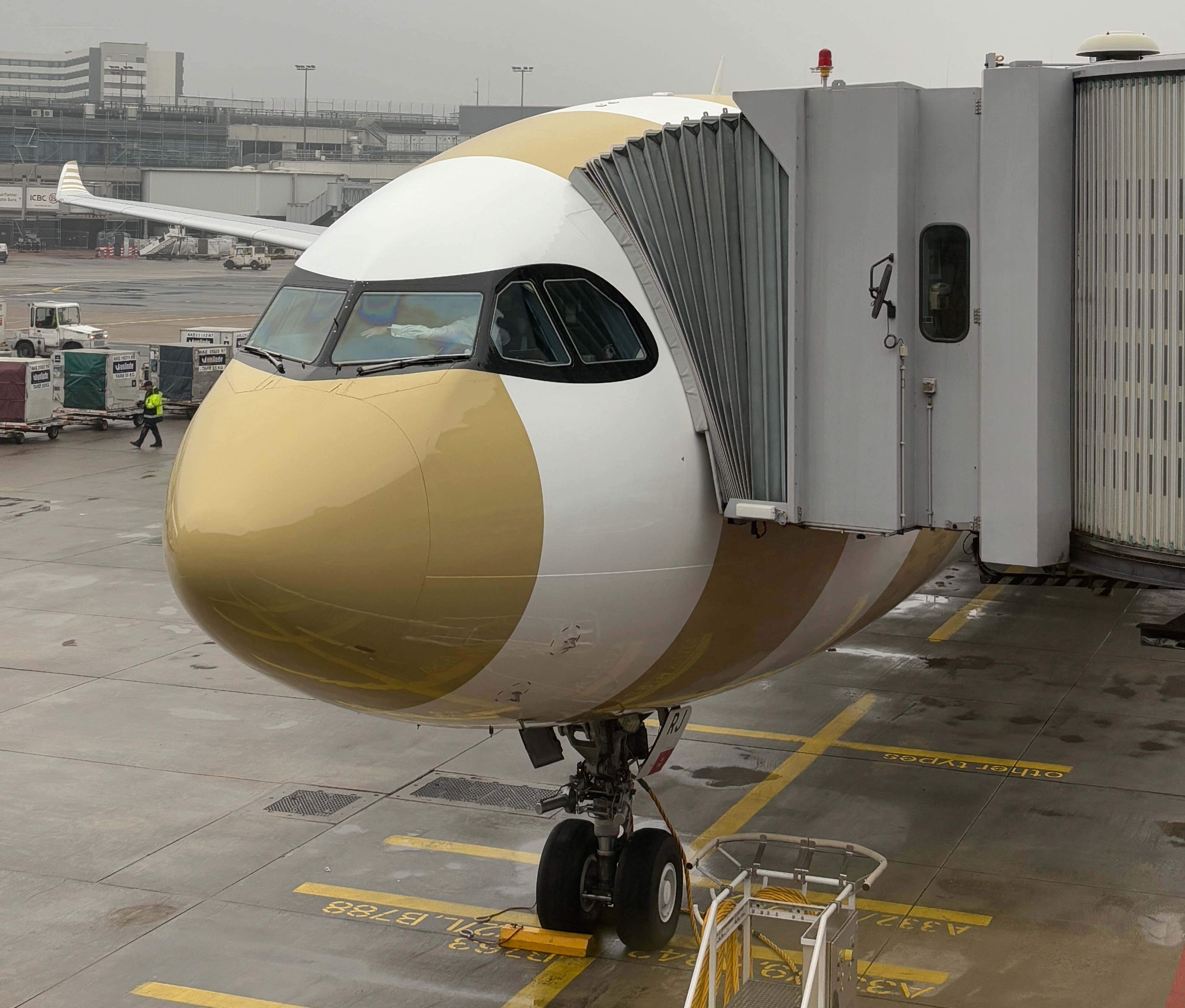 Condor plane parked at the gate with jetbridge attached.