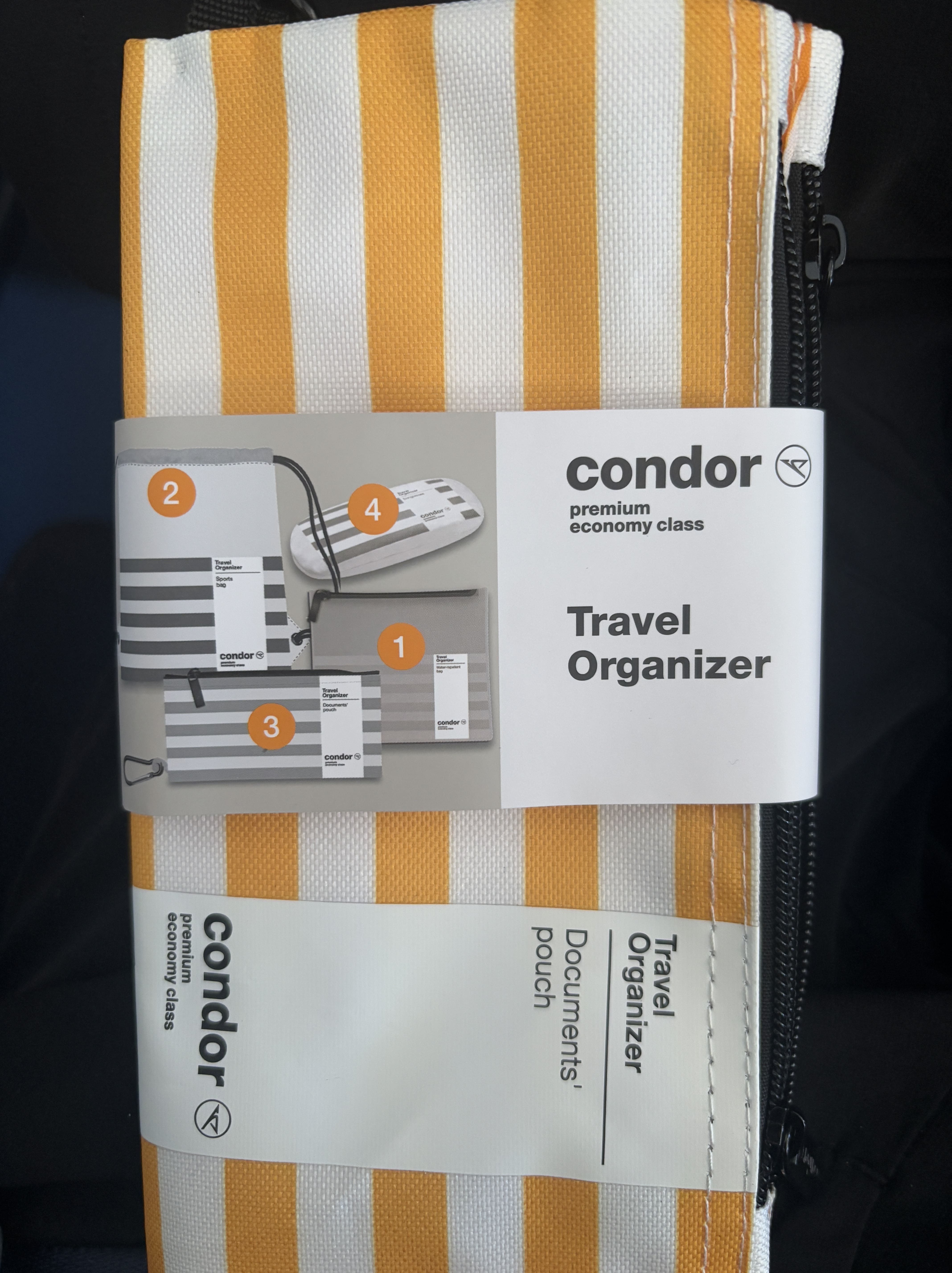 Orange- and white-striped travel organiser provided to Condor premium economy passengers.