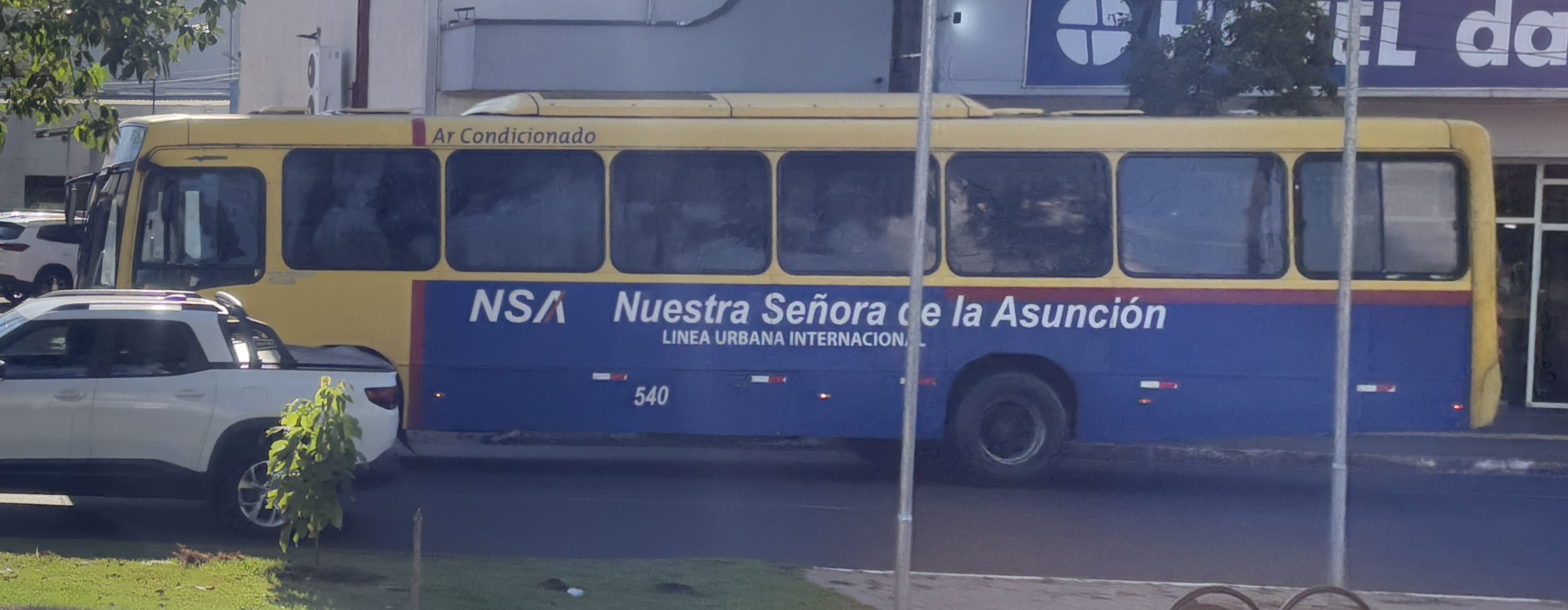 Yellow and blue bus from Nuestra Señora de la Asunción.