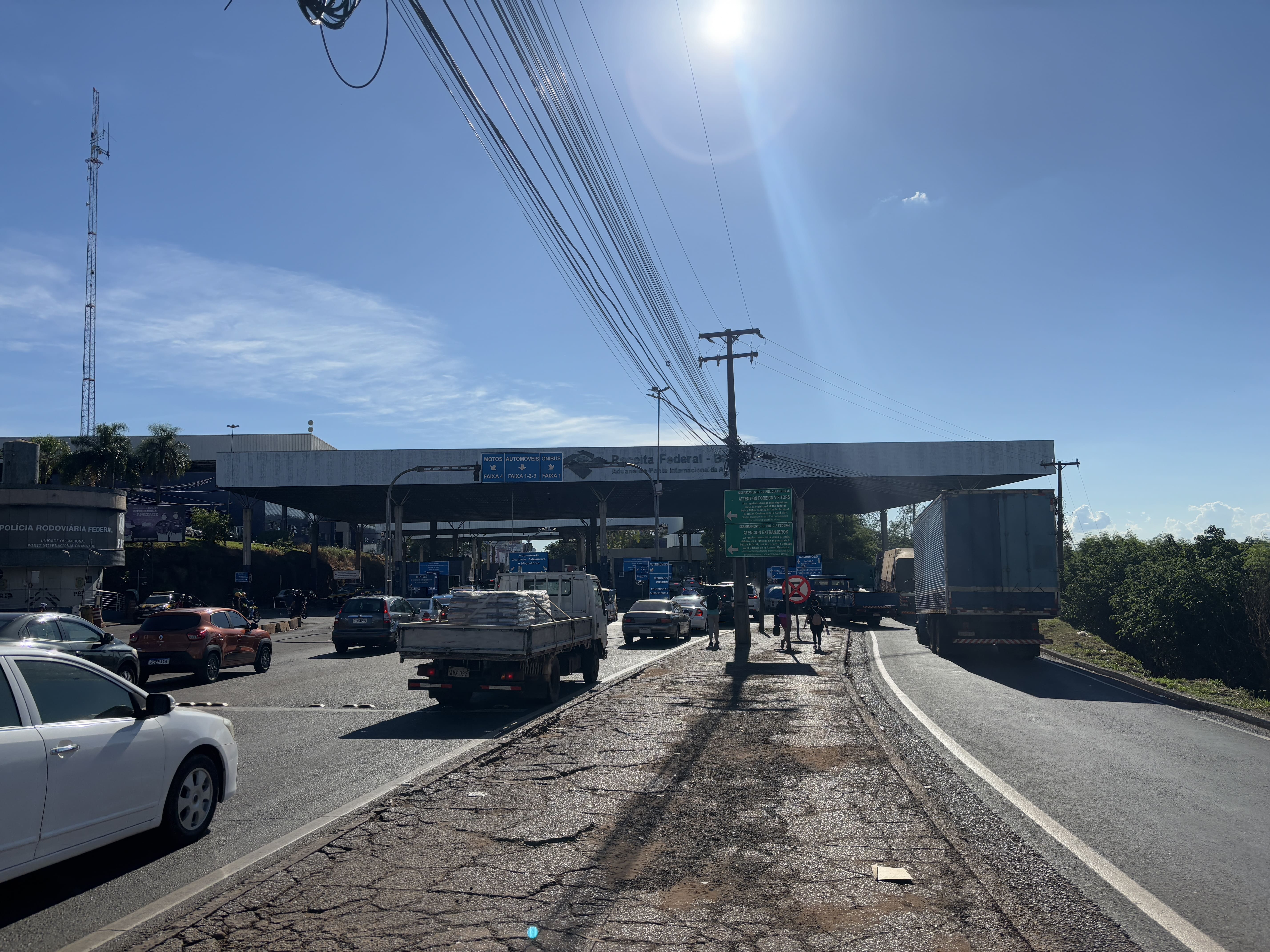 Broken pavement in the median between car and light truck traffic to the left and heavy truck traffic on the right.
