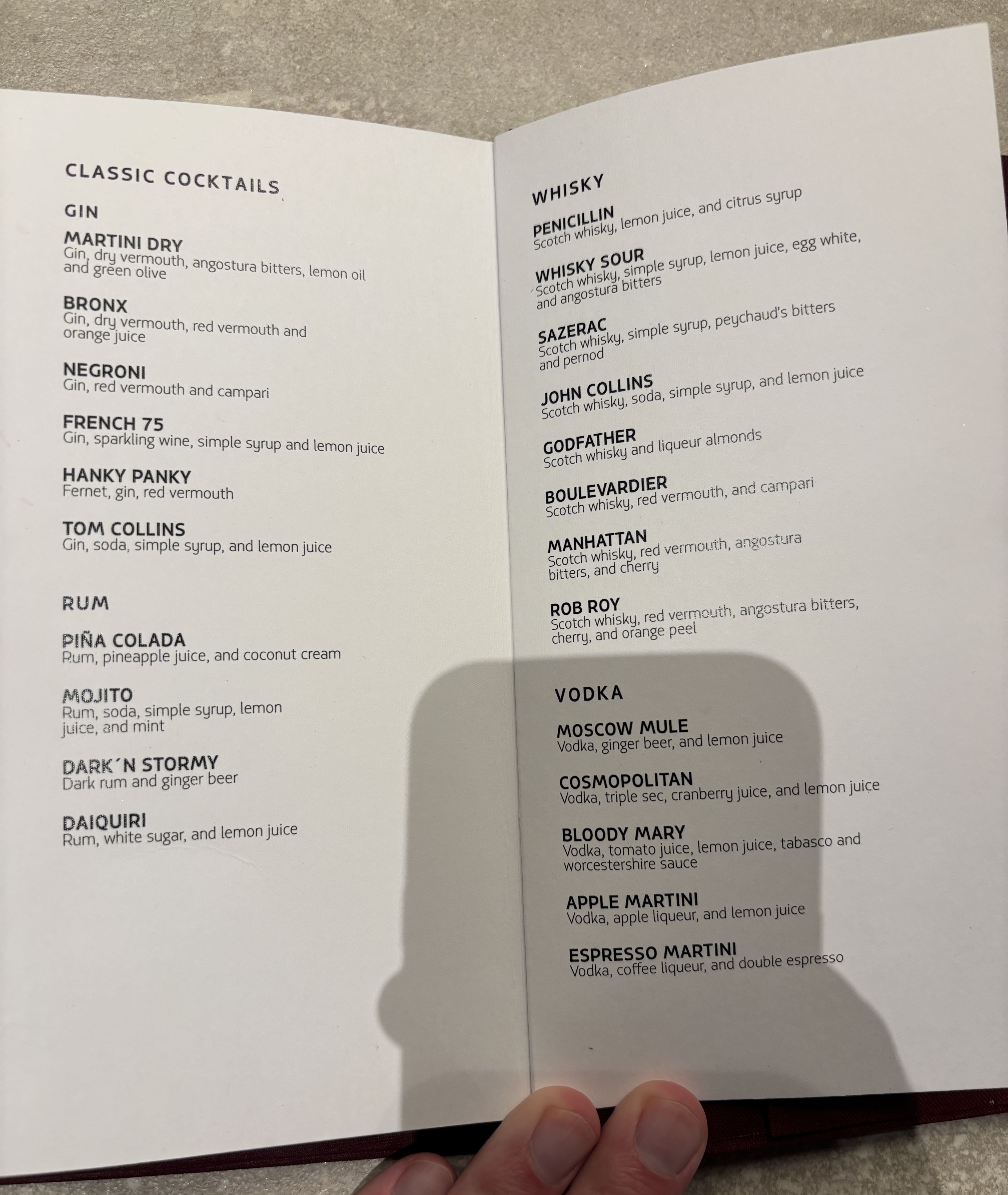 Open cocktail menu, showing gin, rum, vodka, and whiskey cocktail options.