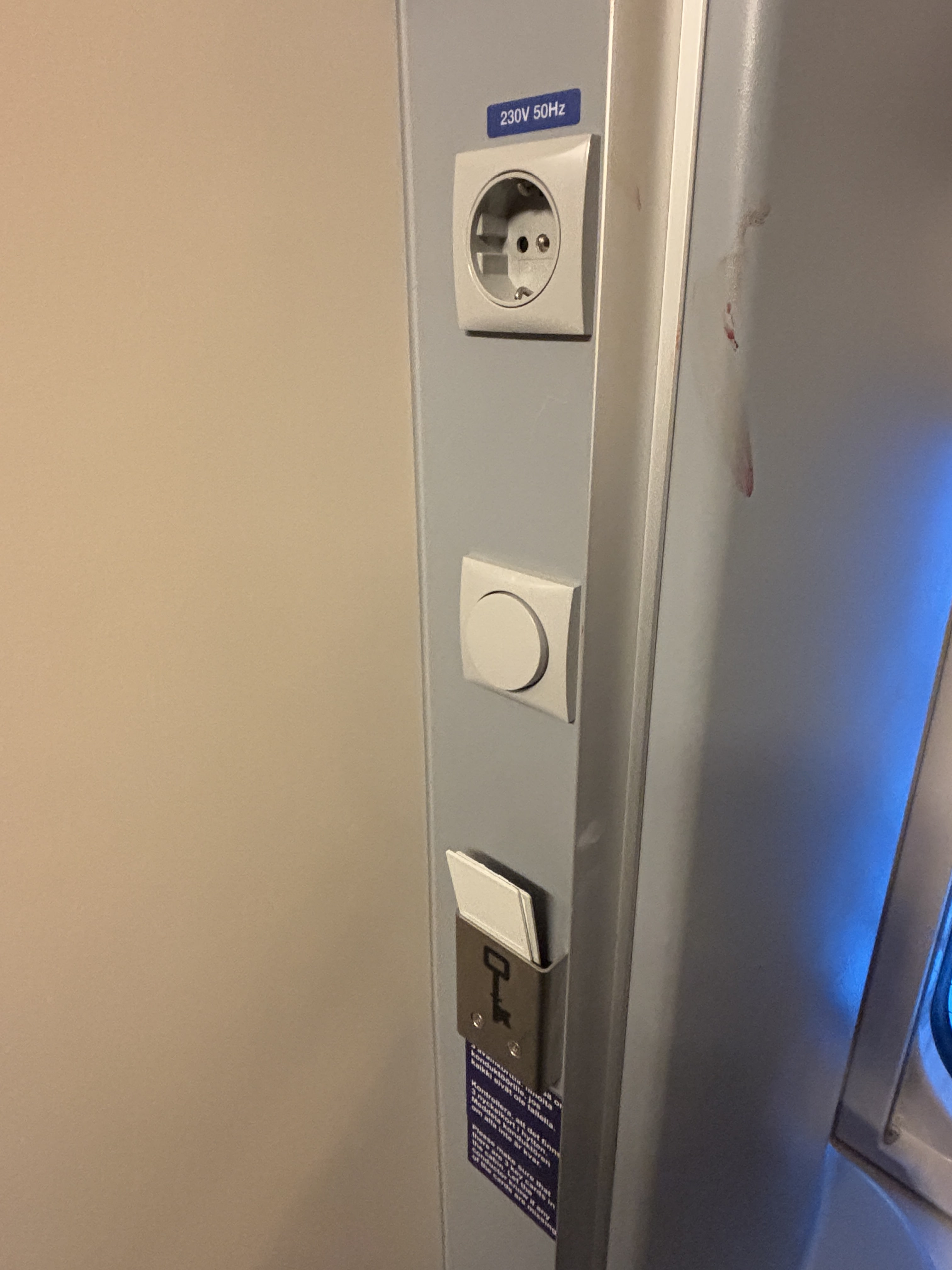 Power outlet, light switch, and key cards for cabin and shower are mounted at the side of the washbasin.